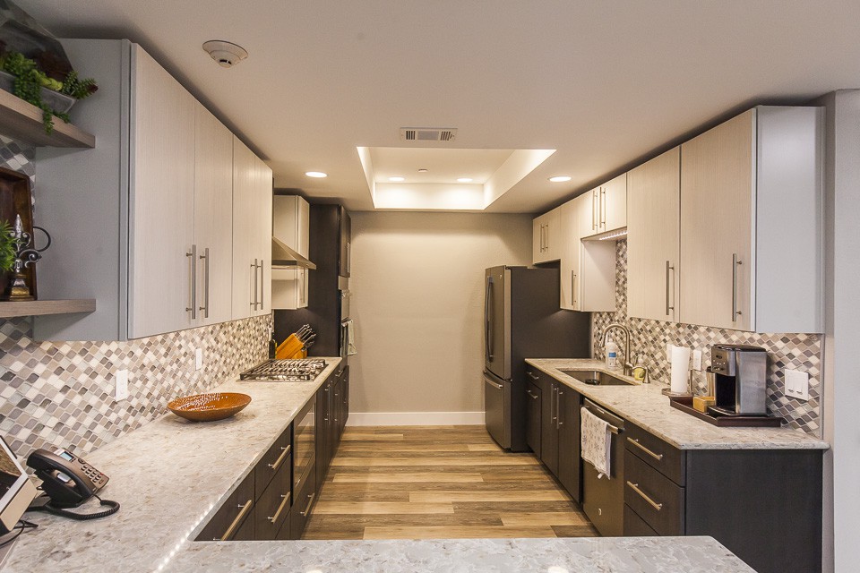 Modern kitchen with sleek design and ample lighting.