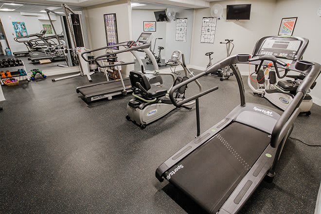 A modern gym equipped with treadmills and exercise bikes.