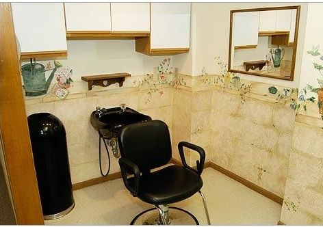 A cozy hair salon setup with a barber chair and washing station.