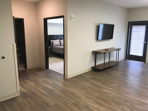A modern living space featuring a television, a wooden console table, and a cozy ambiance.