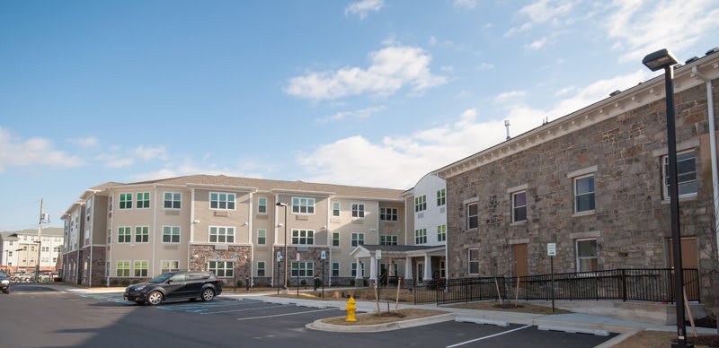A modern residential apartment complex under a cloudy sky.