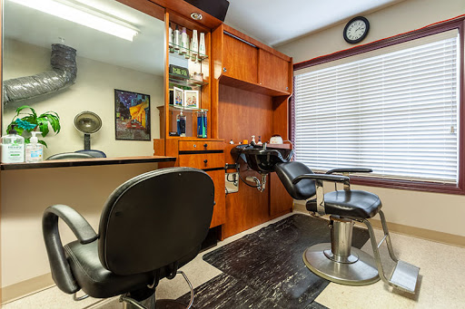 A stylish and well-organized barber shop interior featuring comfortable chairs and essential grooming tools.