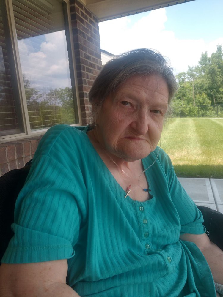 A person sitting outside on a sunny day.