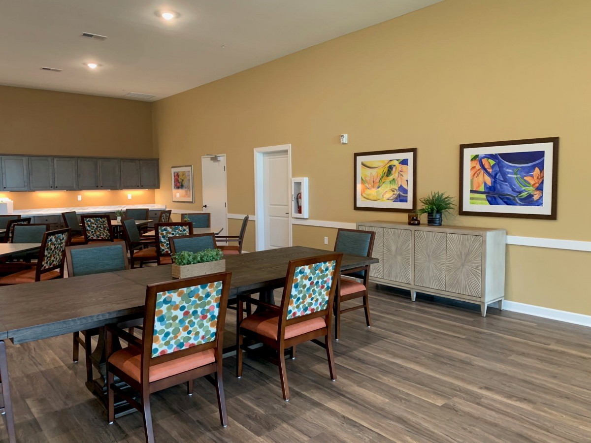 A modern dining room with colorful artwork and stylish furniture.