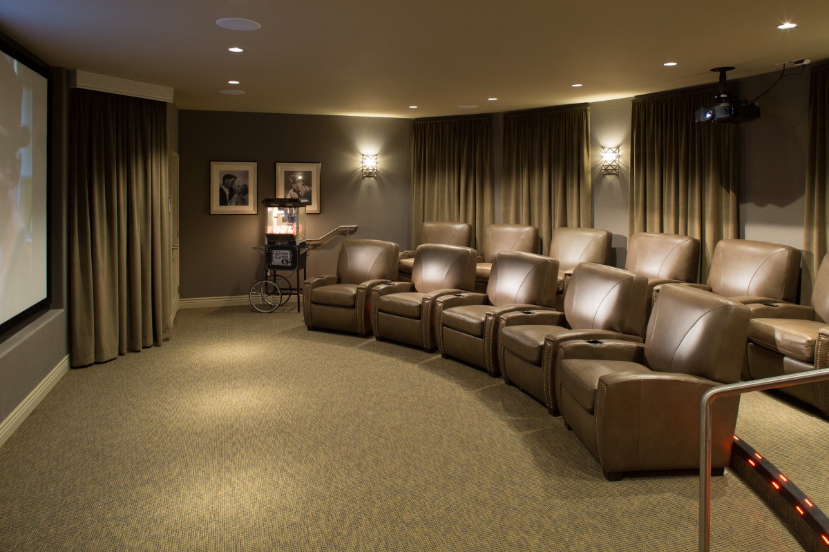 A cozy home theater with leather recliners and ambient lighting.