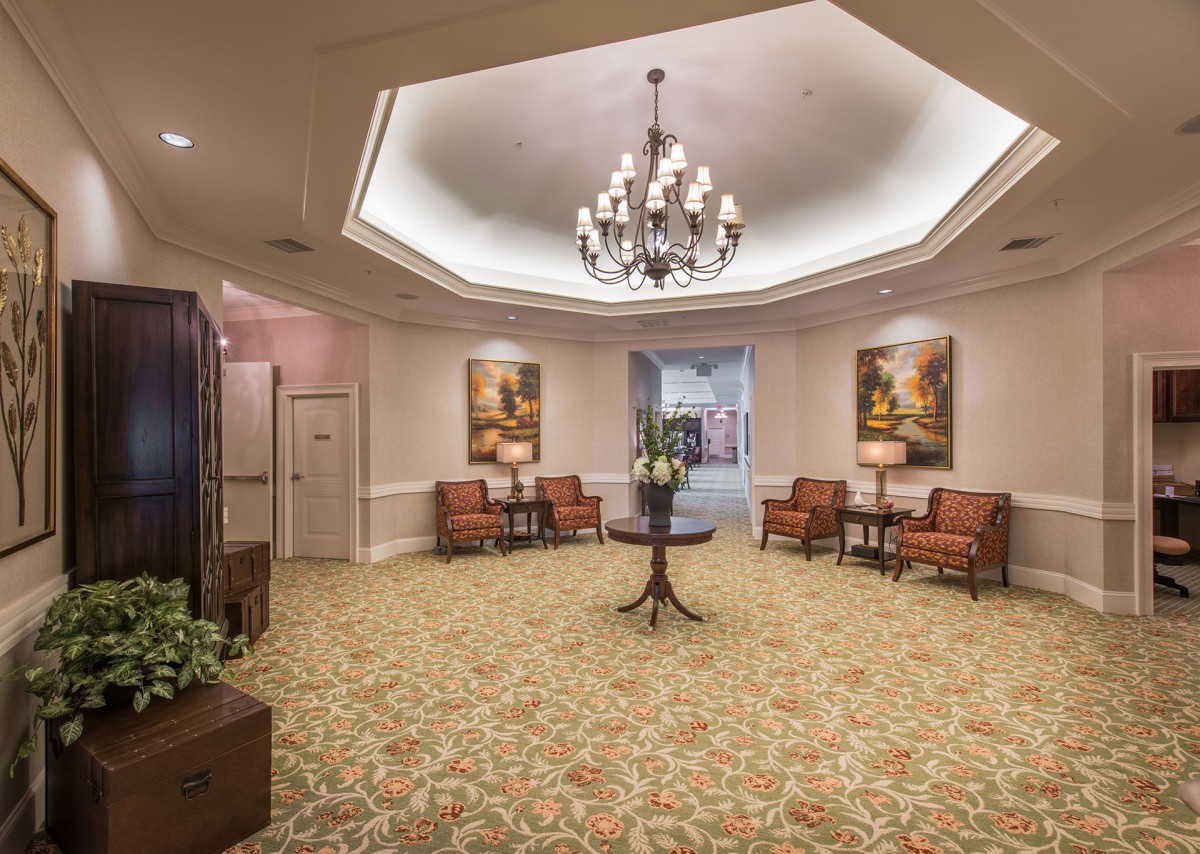 An elegant lobby with a chandelier and sophisticated decor.