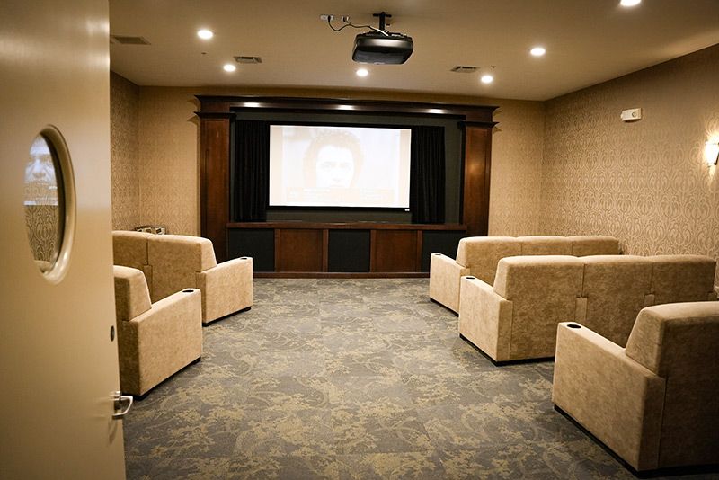 A cozy home theater with comfortable seating and a large screen.