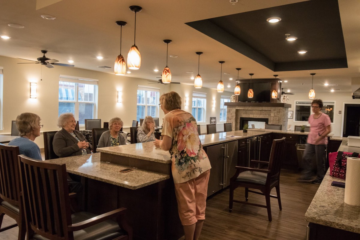 A group of people enjoying a social gathering at a restaurant's bar area.