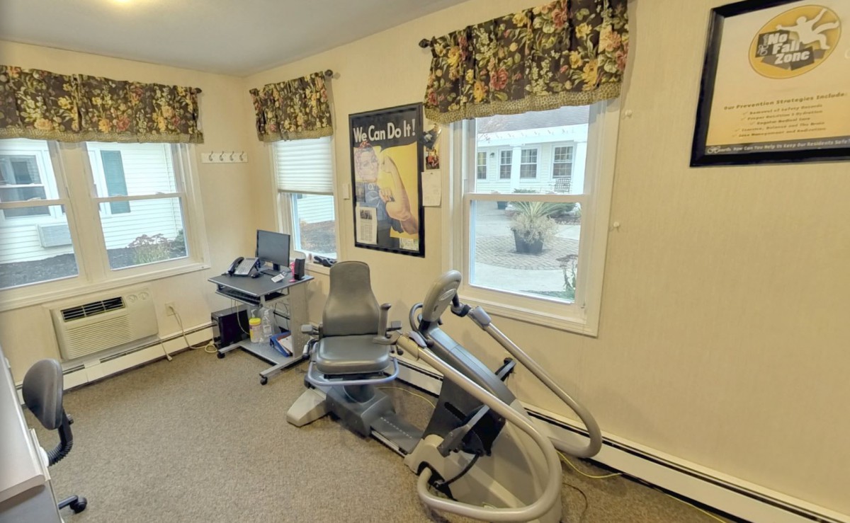 A small indoor gym with exercise equipment and natural light.