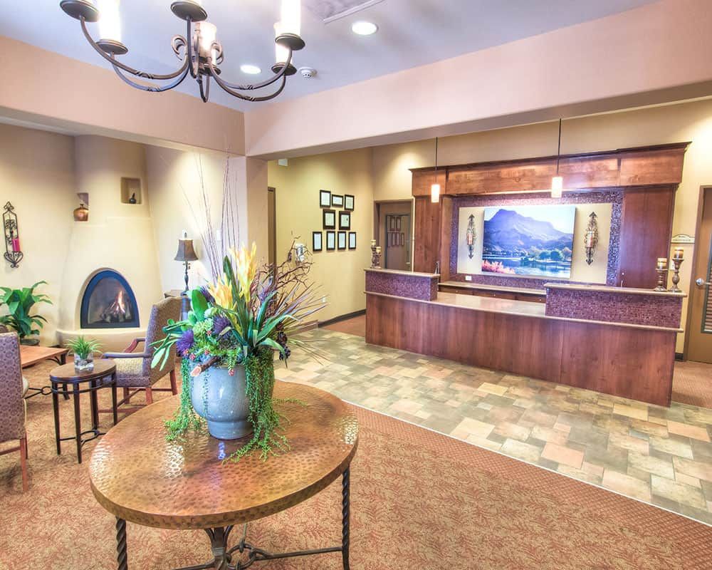 A welcoming hotel lobby with a front desk and elegant decor.