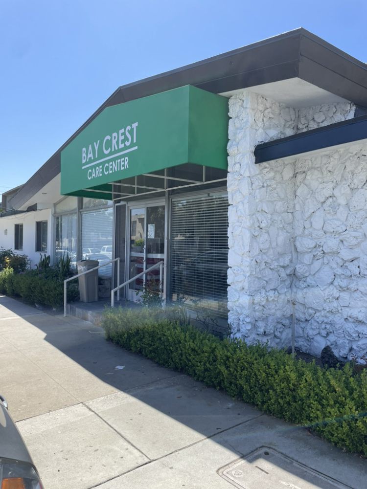 The exterior of a building with a green awning reading 'Bay Crest Catering'.