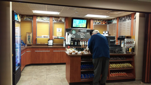 A man browsing the offerings at a coffee shop.