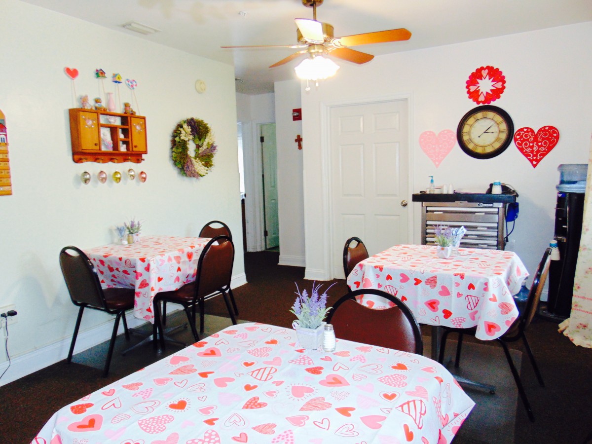 A cozy dining area with Valentine's Day-themed decor and table settings.