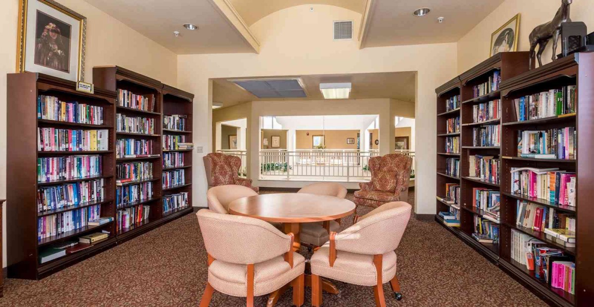 A cozy library reading area with bookshelves and comfortable seating.