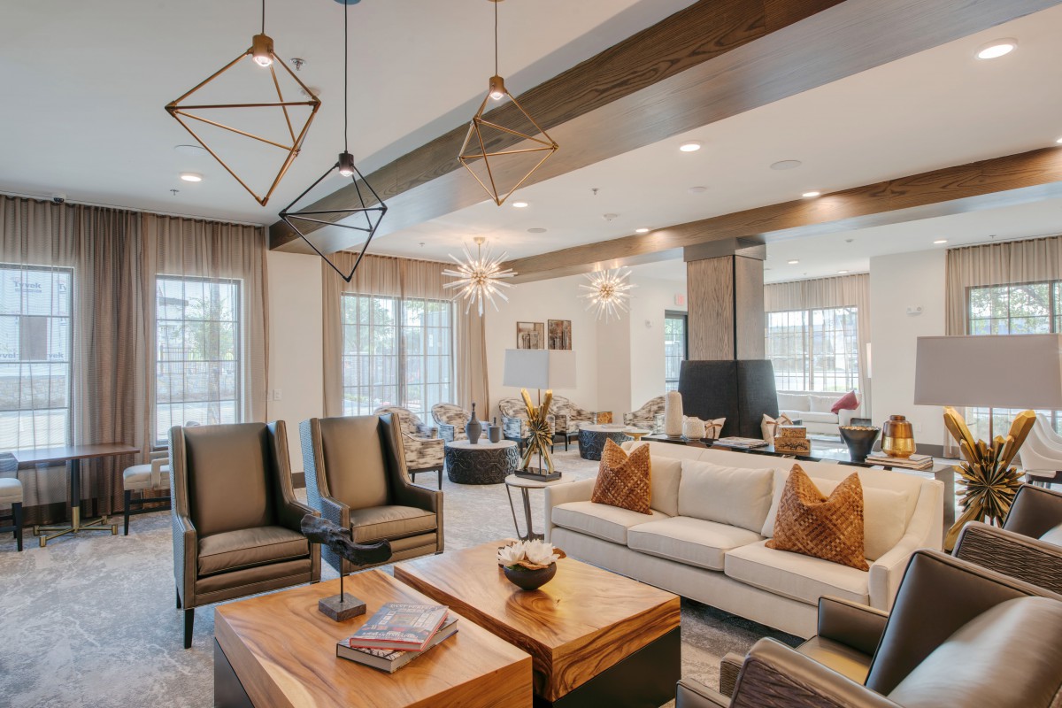 A modern living room with stylish furniture and elegant lighting.