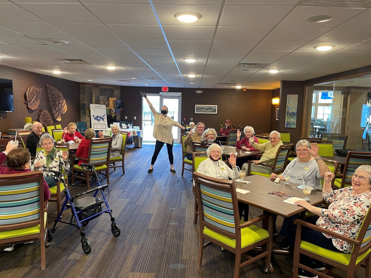 A group of seniors enjoying a social activity inside a nursing home.