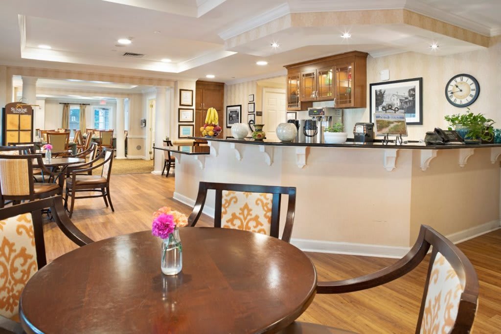 A modern kitchen and dining area with elegant decor and wood flooring.