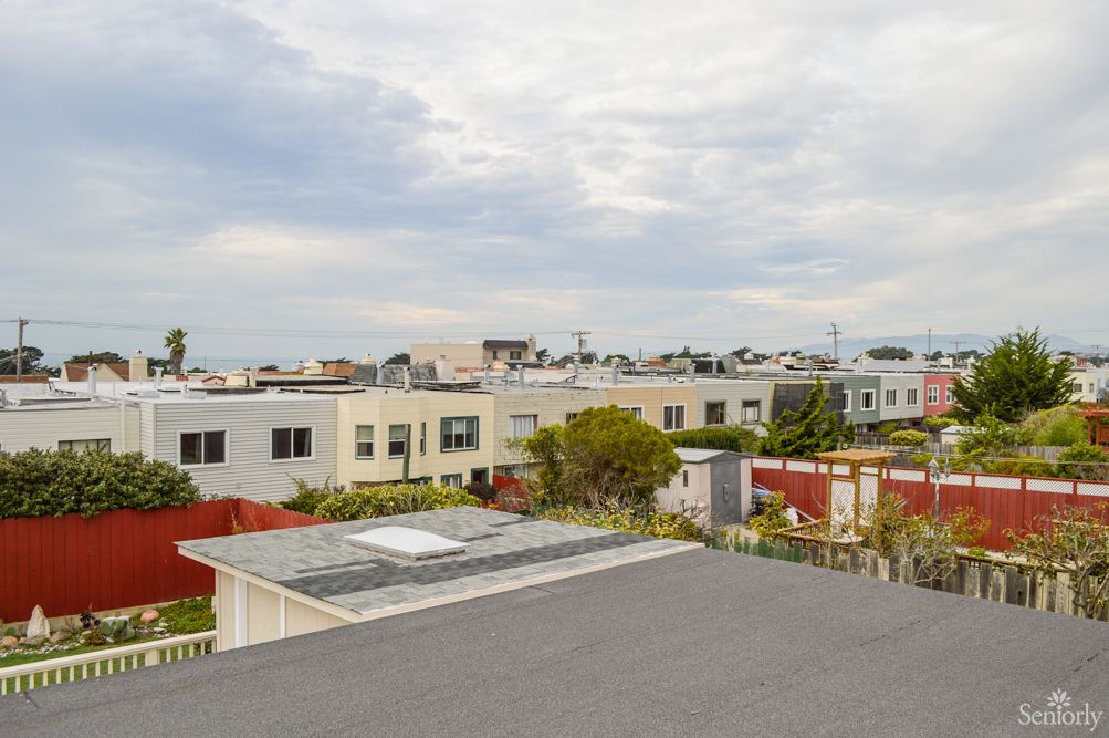 A scenic view of a suburban neighborhood with modern houses and overcast skies.