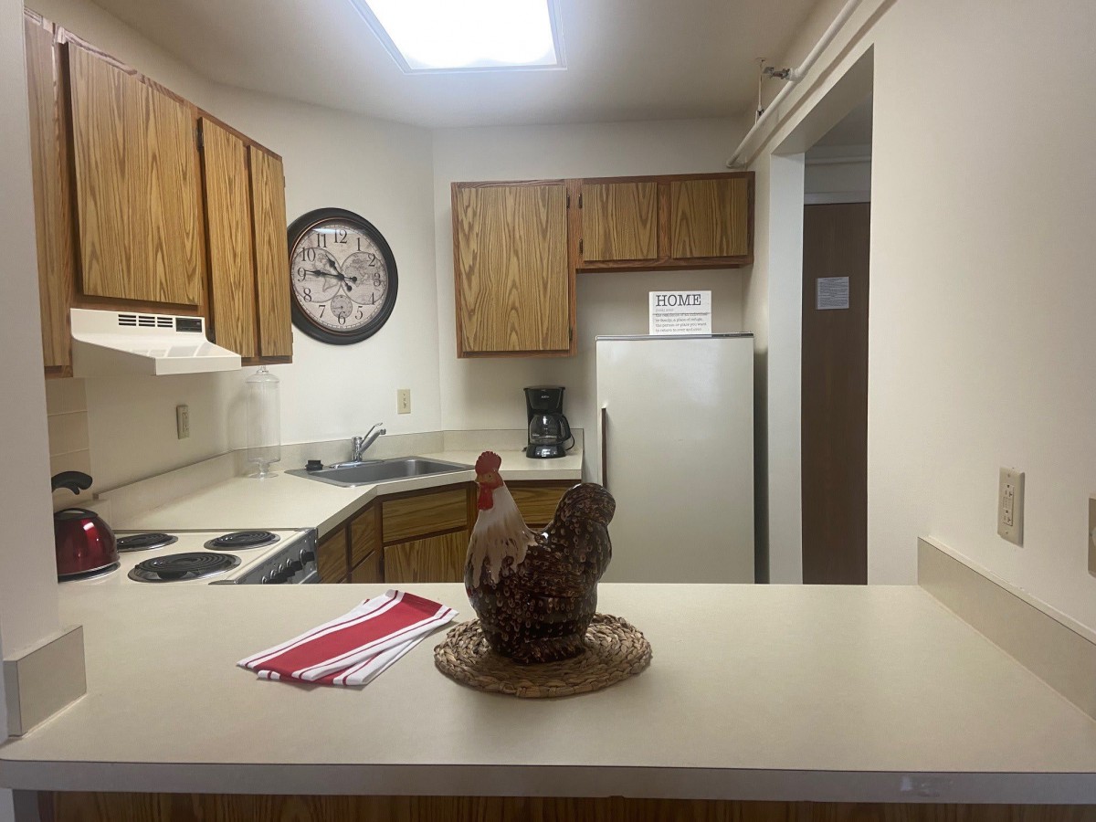 A cozy kitchen with wooden cabinets and modern appliances.