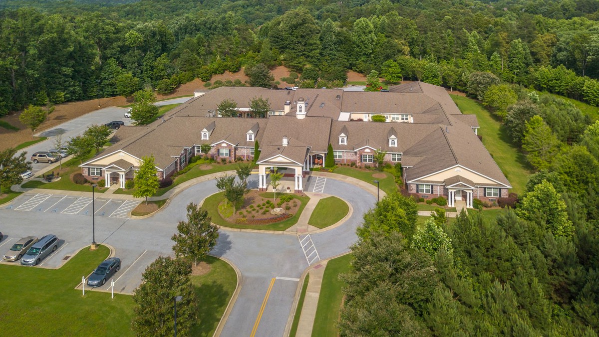 Aerial view of a large building complex surrounded by greenery.