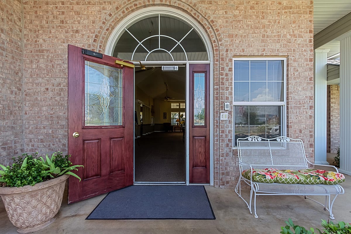 An inviting entrance with a red double door on a brick building.