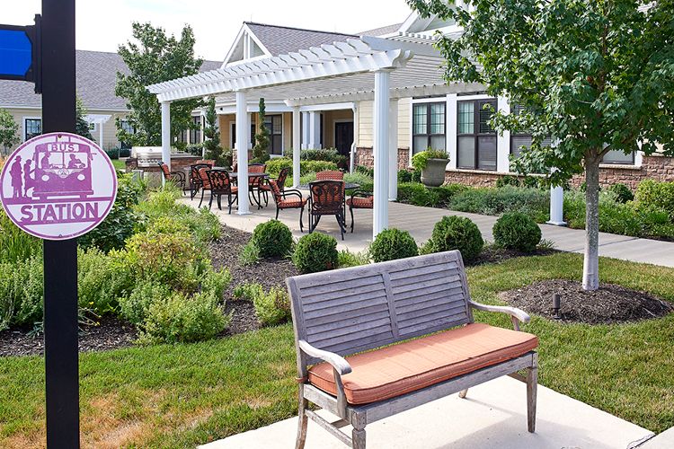 A beautifully landscaped garden with seating areas and a pergola.