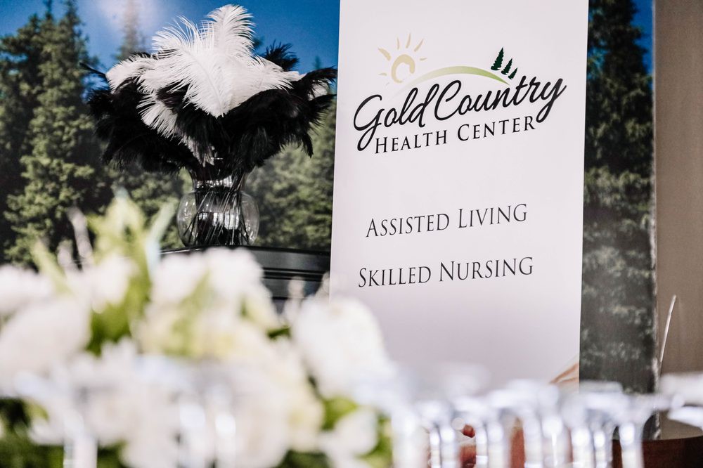 A sign for Gold Country Health Center offering assisted living and skilled nursing services.