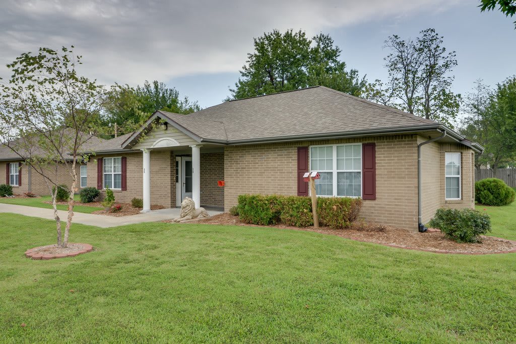 A single-story suburban house with a well-maintained lawn and simple landscaping.