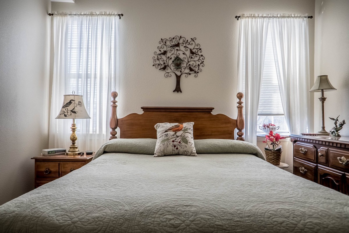 A cozy bedroom with elegant decor and soft lighting.