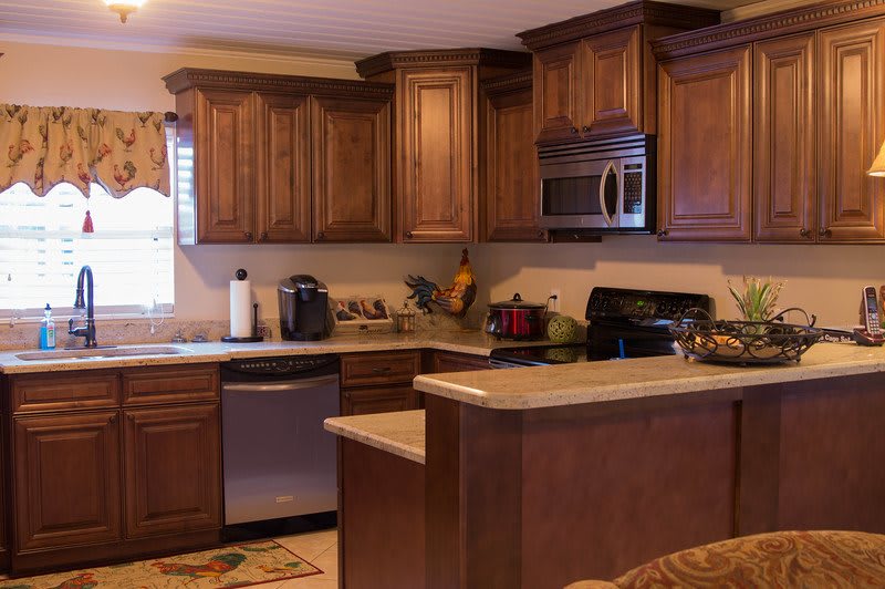 A cozy kitchen with wooden cabinets and modern appliances.