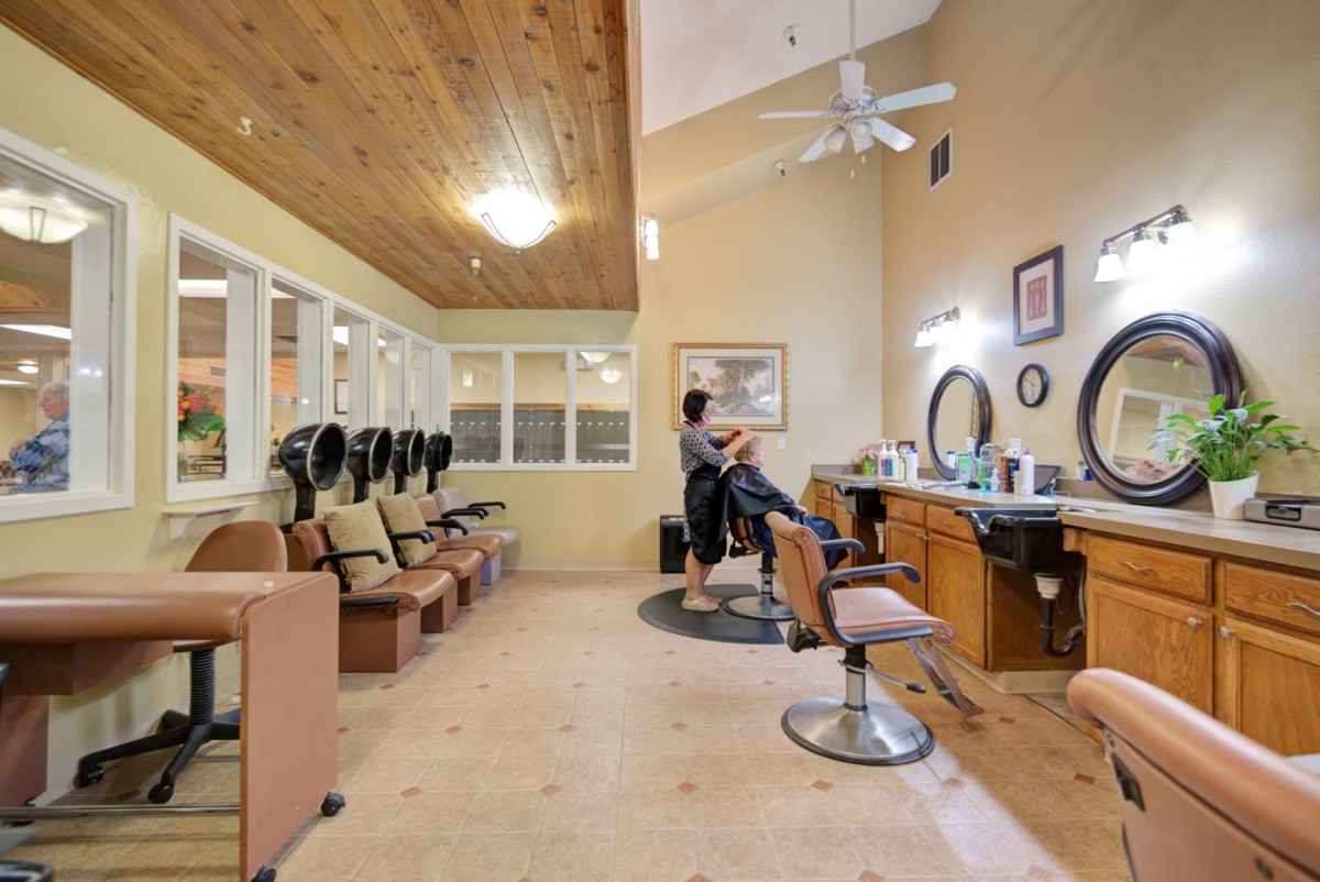 A cozy hair salon interior with styling stations and comfortable seating.
