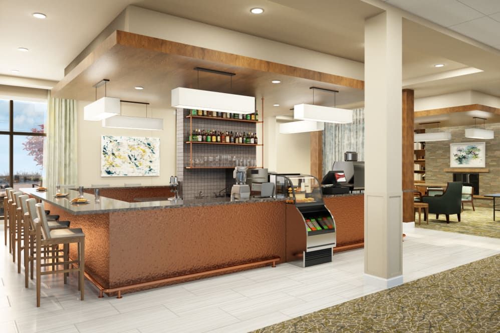 A modern coffee shop interior with a stylish counter and beverage display.