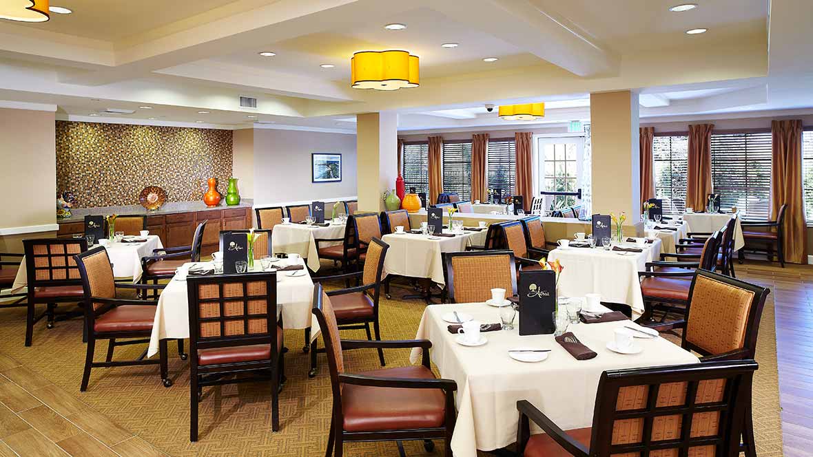 Elegant restaurant dining area with neatly set tables and comfortable chairs.