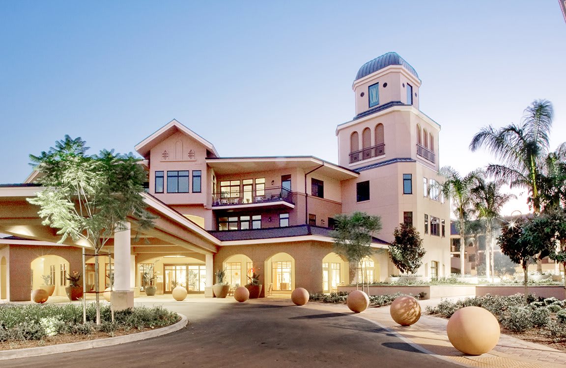 A luxurious hotel with a prominent tower and elegant architecture.