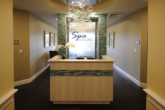 A welcoming reception area of a modern spa with elegant decor.