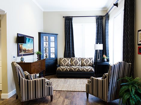 A stylish living room with patterned furniture and elegant decor.