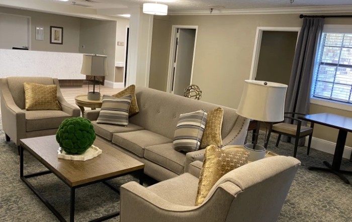 A modern living room with a beige sofa set, coffee table, and stylish decor.