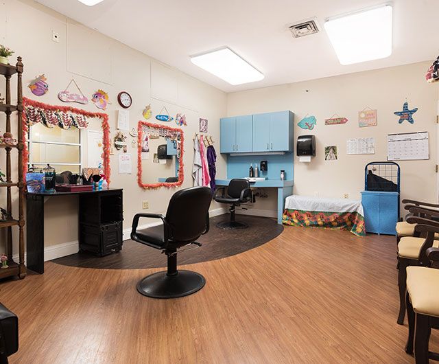 A well-decorated hair salon interior with styling chairs and colorful wall decor.