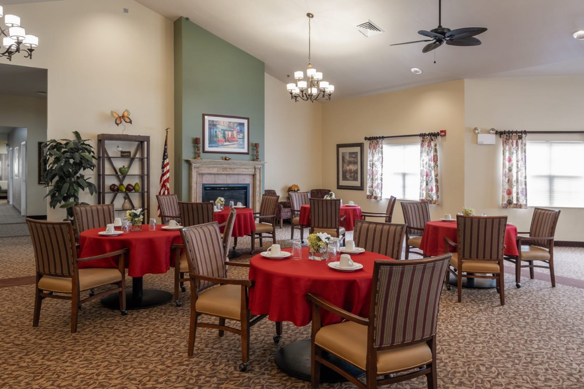 A cozy dining room with red tablecloths and elegant decor.