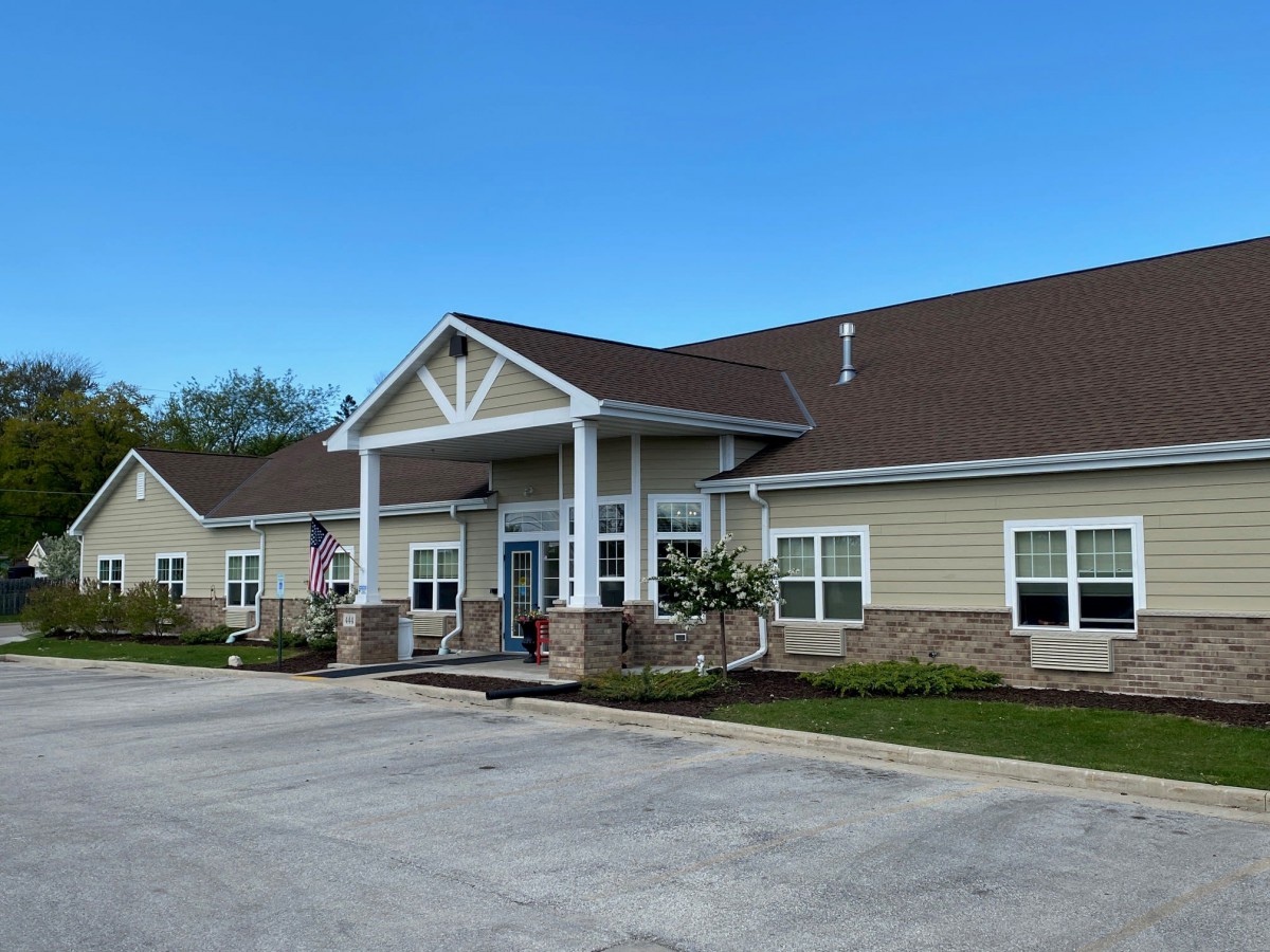 A suburban residential building with a prominent entrance and well-maintained landscaping.