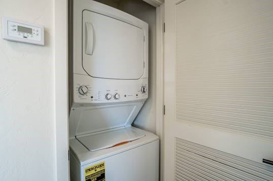 Stacked washer and dryer in a small laundry closet.