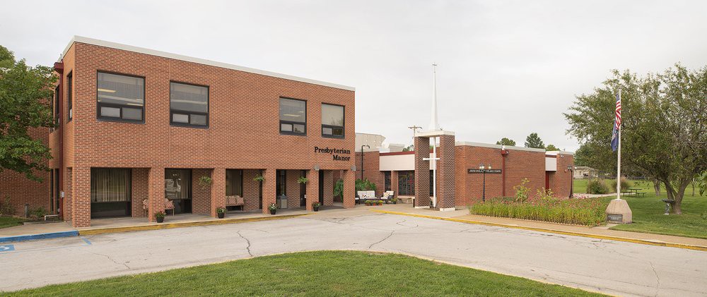 A brick hospital building with an entrance, photographed during the daytime.