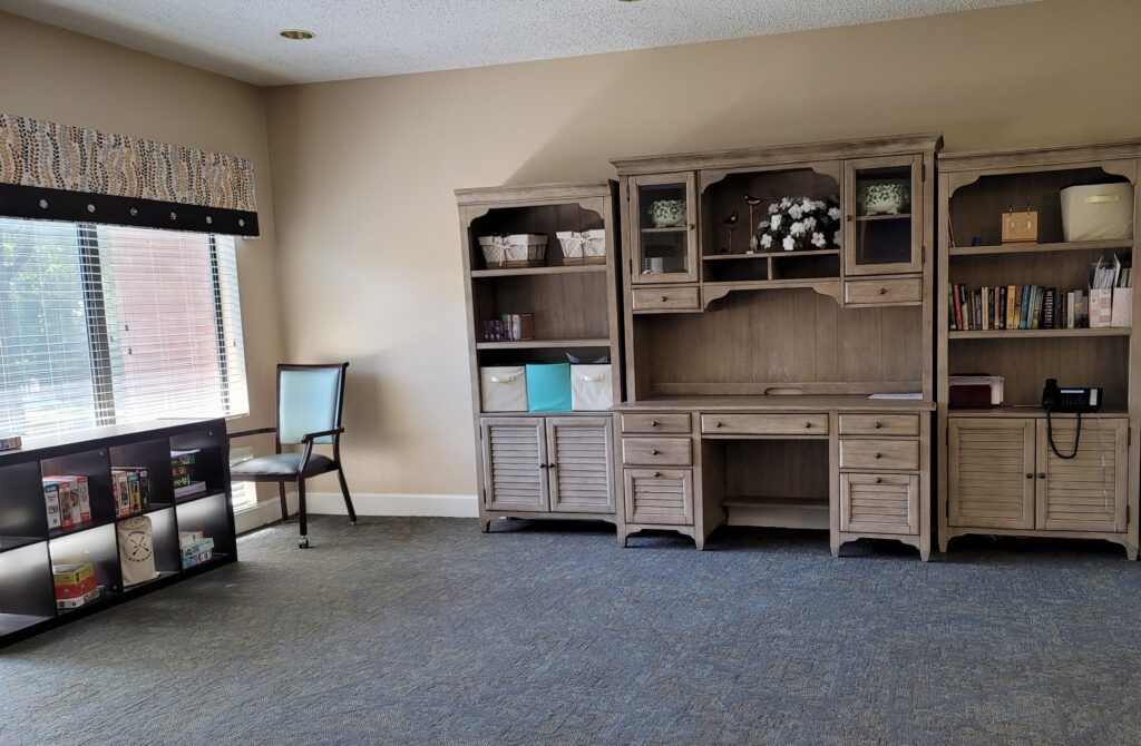 An office workspace with a desk and shelves.