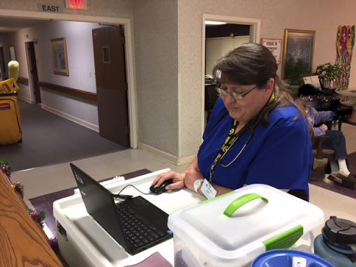 An employee working at a workstation in a healthcare facility.