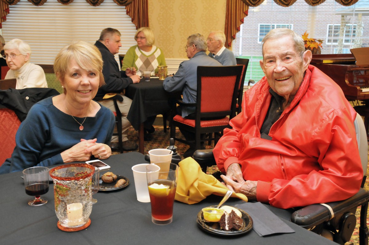 A group of people enjoying a meal together at an indoor social event.