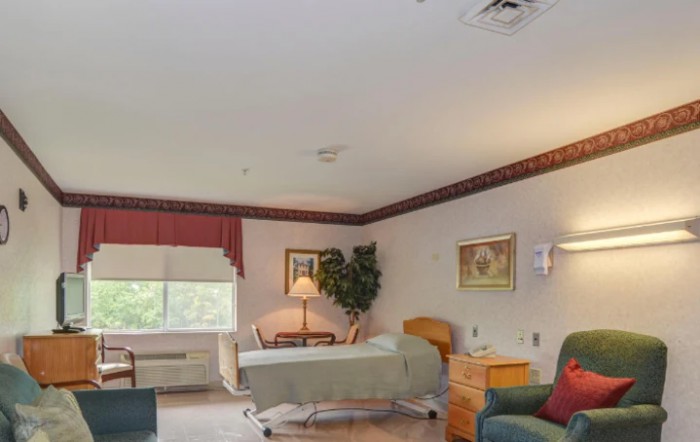 A well-lit hospital room with a bed, side table, and decorative elements.