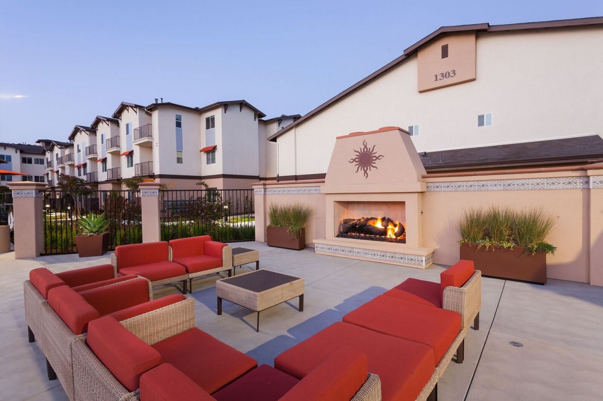 Outdoor seating area with a fireplace at a hotel.