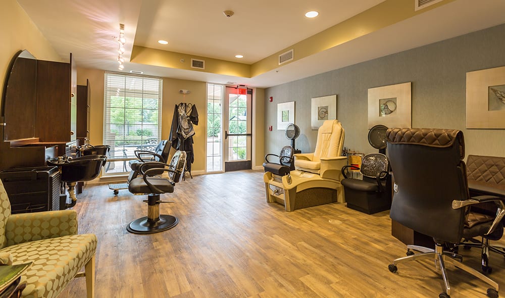 A modern hair and spa salon interior featuring comfortable chairs and sleek decor.
