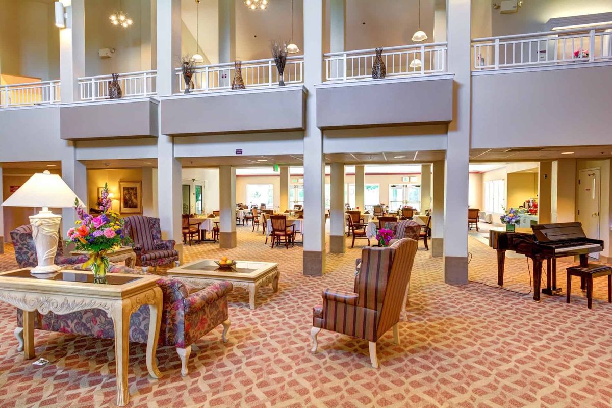 A spacious and elegantly furnished hotel lobby with high ceilings and comfortable seating areas.