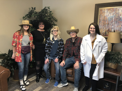 A fun gathering with friends dressed in playful costumes and hats.